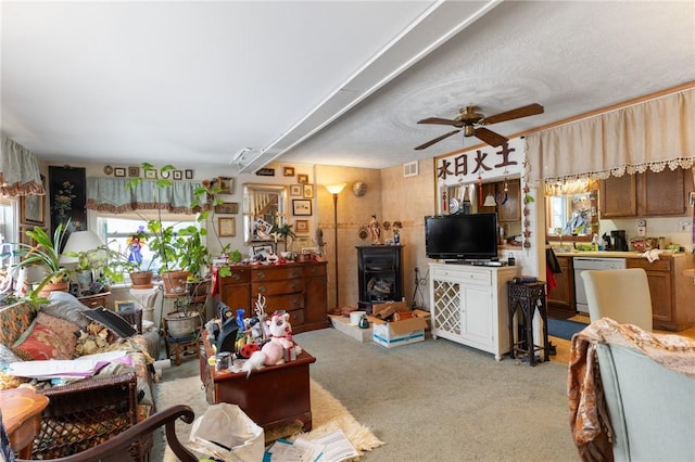 carpeted living room with ceiling fan