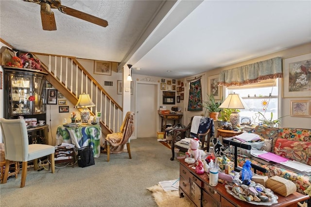 living room featuring a textured ceiling, light colored carpet, and ceiling fan