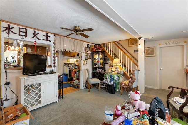 carpeted living room featuring a textured ceiling and ceiling fan