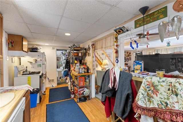 misc room with a paneled ceiling and hardwood / wood-style floors