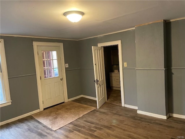 foyer entrance featuring ornamental molding and dark hardwood / wood-style flooring