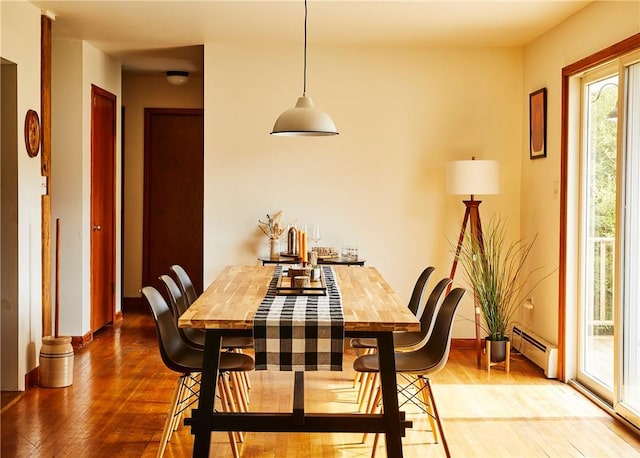 dining room with hardwood / wood-style floors and a baseboard radiator