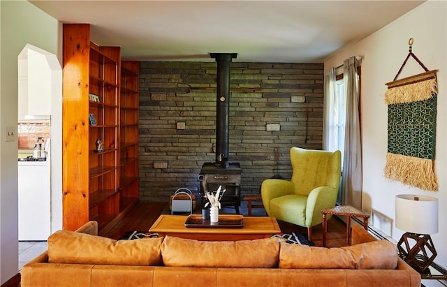 living room featuring hardwood / wood-style flooring and a wood stove