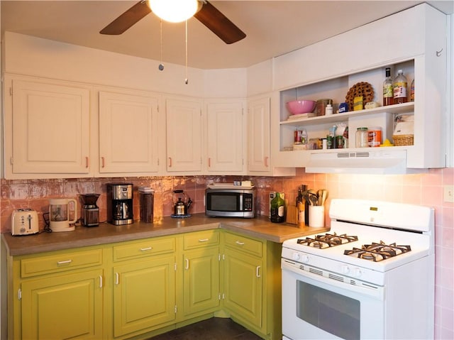 kitchen featuring white gas range, backsplash, and ceiling fan