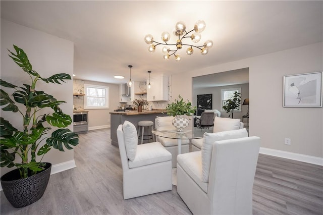 dining area featuring an inviting chandelier and hardwood / wood-style flooring