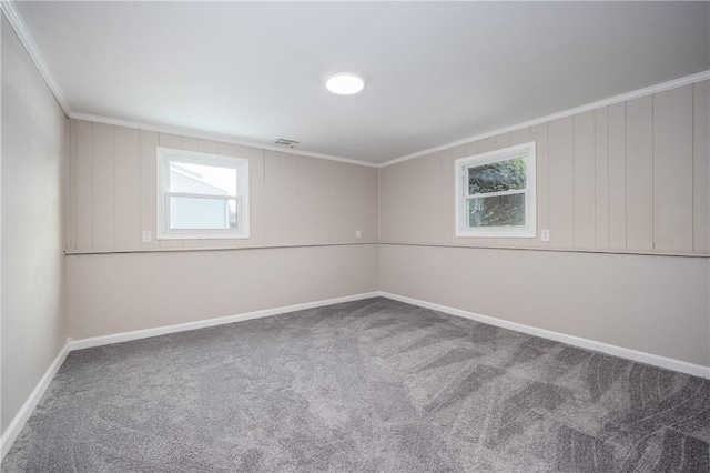 carpeted spare room featuring crown molding