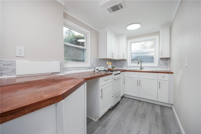 kitchen featuring wood counters, sink, white gas range, light hardwood / wood-style floors, and white cabinets