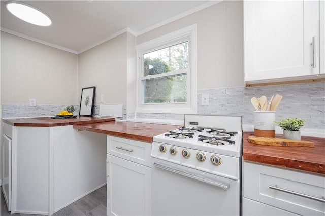 kitchen featuring white range with gas cooktop, butcher block countertops, and white cabinetry