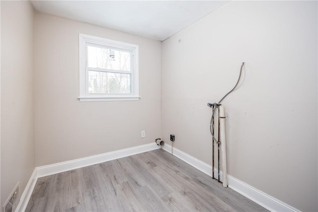 laundry room featuring washer hookup and light wood-type flooring