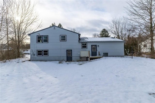 view of snow covered back of property