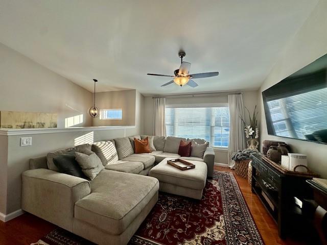 living room with ceiling fan, dark wood-type flooring, and lofted ceiling