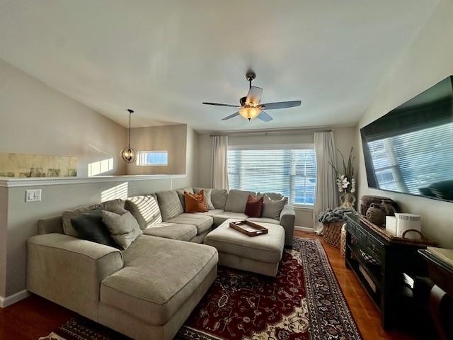 living room with ceiling fan, dark hardwood / wood-style floors, and lofted ceiling