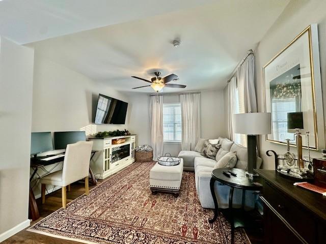 living room with ceiling fan and dark hardwood / wood-style flooring