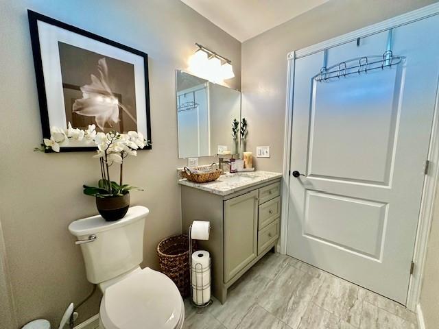 bathroom featuring vanity and toilet