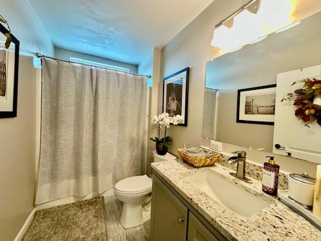 bathroom featuring toilet and vanity