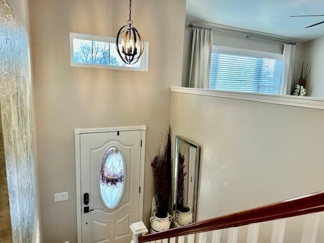 entryway featuring a wealth of natural light and a chandelier