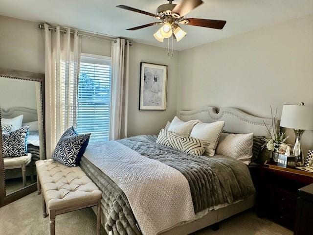 bedroom featuring light carpet and ceiling fan