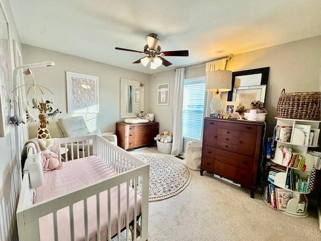 carpeted bedroom with ceiling fan