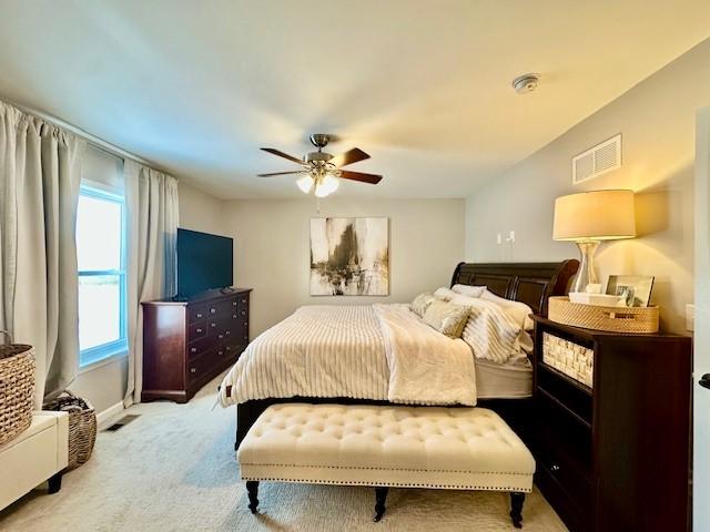 bedroom with ceiling fan and light carpet