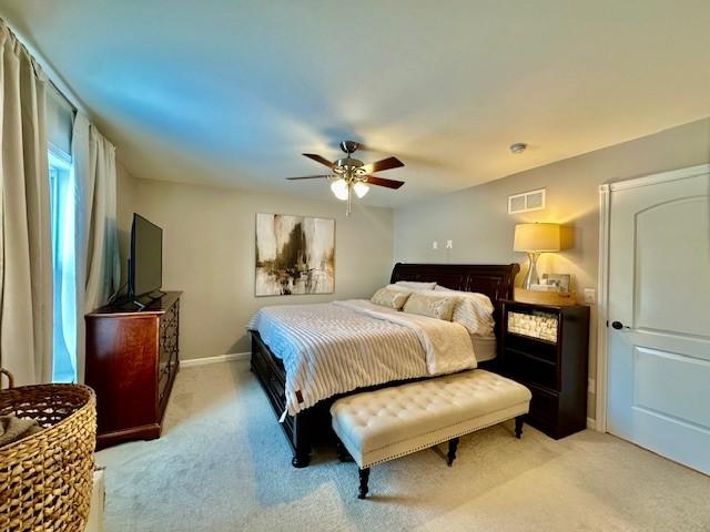 bedroom featuring ceiling fan and light carpet