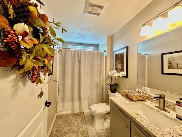 bathroom featuring hardwood / wood-style floors, toilet, and vanity