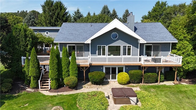 back of house with a wooden deck and a yard