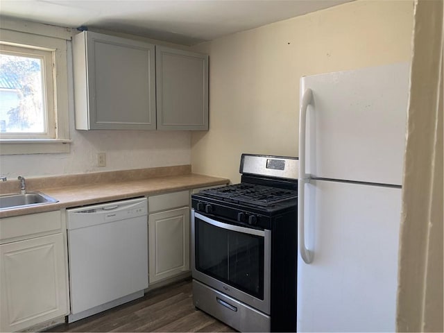 kitchen with white cabinets, white appliances, and dark hardwood / wood-style floors