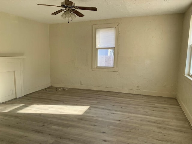 spare room featuring ceiling fan and light wood-type flooring