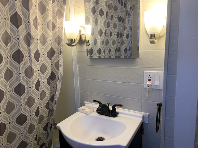 bathroom featuring sink, tasteful backsplash, and tile walls