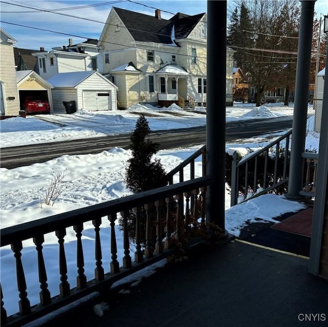 view of snow covered back of property