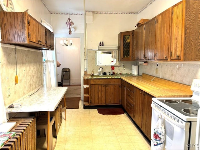 kitchen with sink, white range with electric stovetop, and a notable chandelier