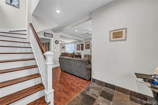 stairs featuring ceiling fan