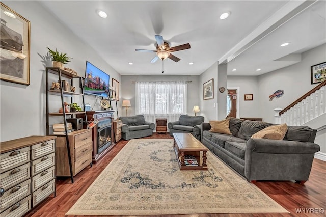 living room with dark hardwood / wood-style floors and ceiling fan