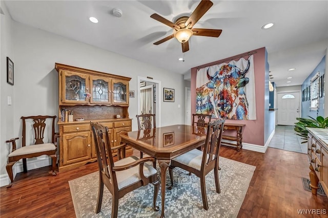 dining room with hardwood / wood-style floors and ceiling fan