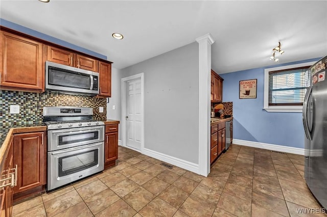 kitchen featuring tasteful backsplash, appliances with stainless steel finishes, and light tile patterned flooring