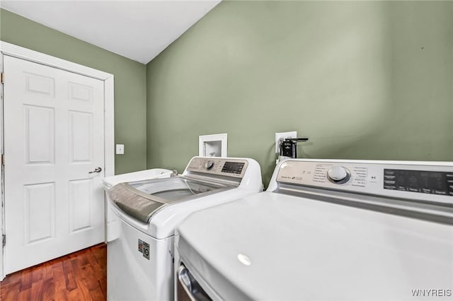 laundry room with washer and dryer and dark hardwood / wood-style floors