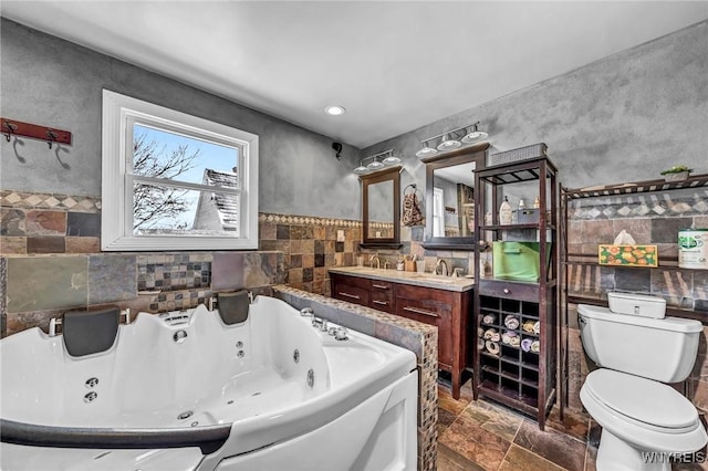 bathroom featuring vanity, toilet, and a bathing tub