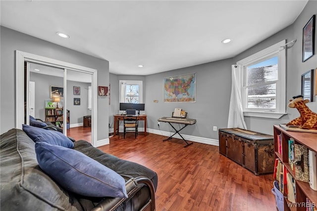 living room with hardwood / wood-style floors and a healthy amount of sunlight