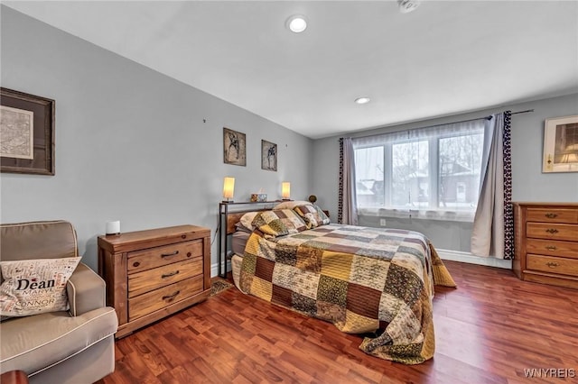 bedroom with dark hardwood / wood-style flooring