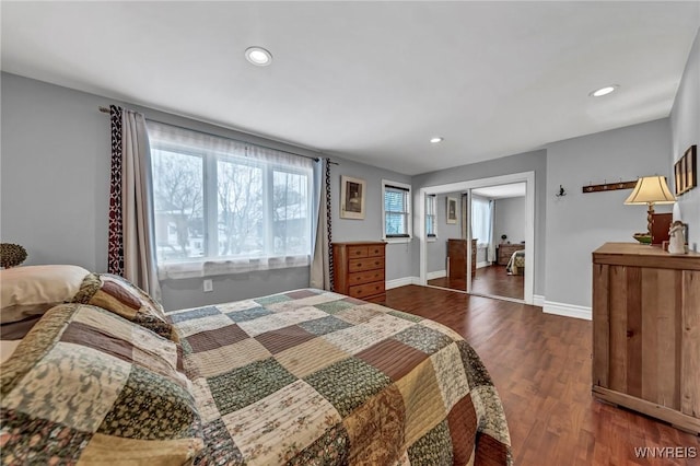 bedroom with dark hardwood / wood-style flooring and a closet