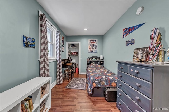 bedroom with hardwood / wood-style floors