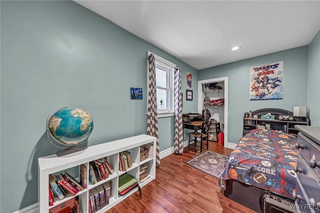 bedroom with hardwood / wood-style flooring