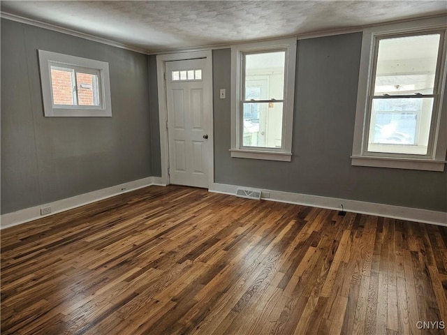 foyer entrance featuring dark wood-type flooring and a textured ceiling