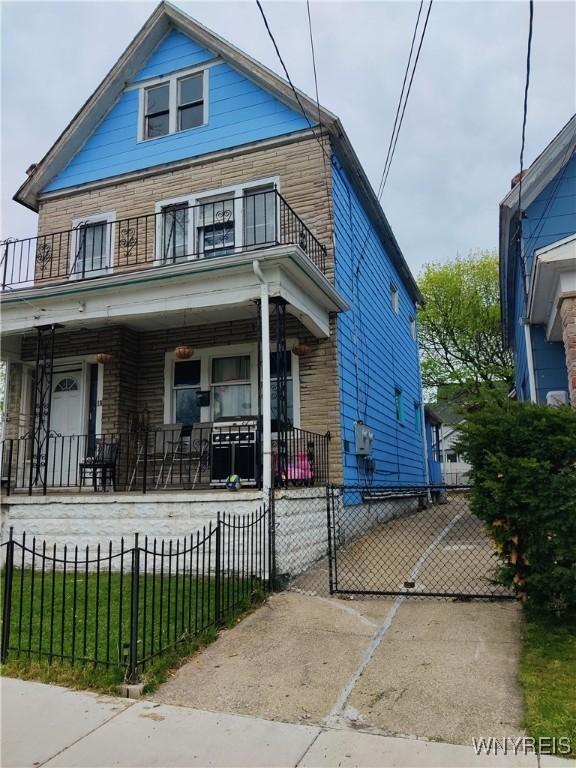 bungalow-style home with a balcony and covered porch