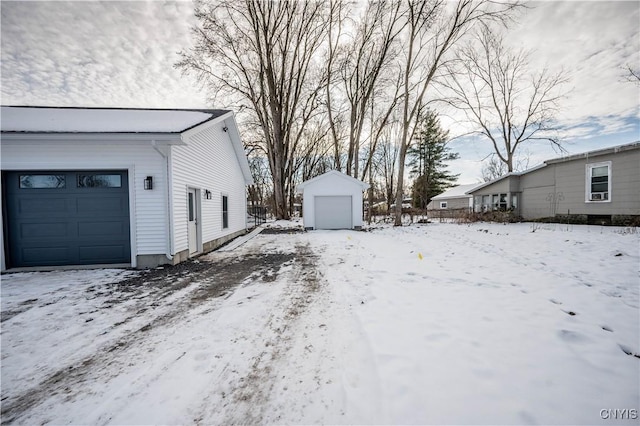 yard layered in snow featuring a garage