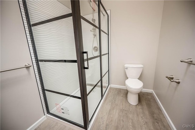 bathroom with wood-type flooring and toilet