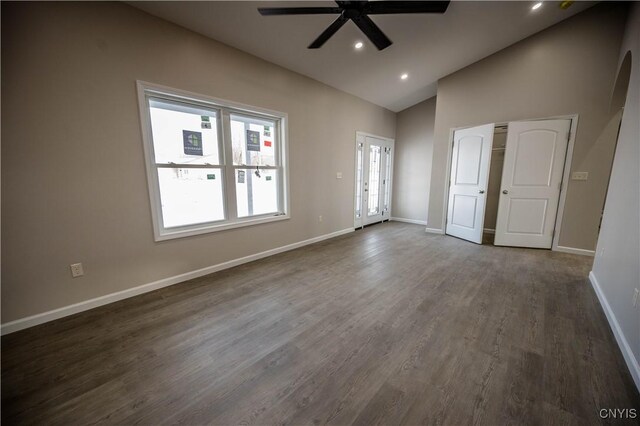 interior space featuring ceiling fan, vaulted ceiling, dark hardwood / wood-style floors, and a healthy amount of sunlight