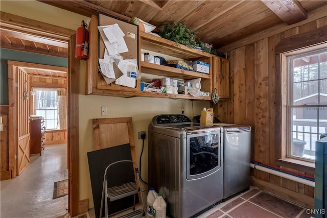 laundry room featuring independent washer and dryer, wooden walls, and wooden ceiling