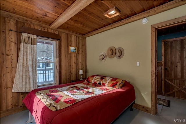 bedroom with beam ceiling, wood ceiling, wooden walls, and concrete floors