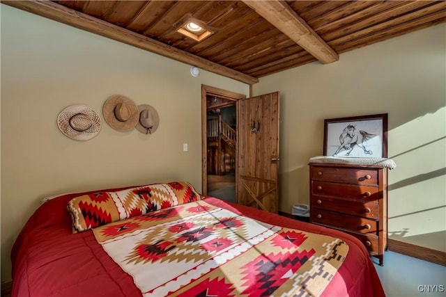 bedroom featuring beamed ceiling and wood ceiling